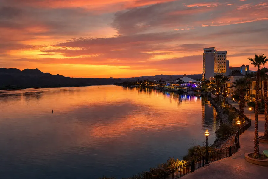 Colorado River at sunset in Laughlin with riverwalk lights