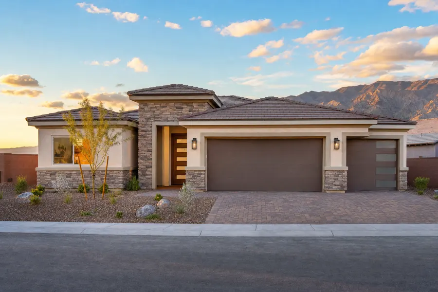 New-construction single-story suburban home with desert landscaping at golden hour